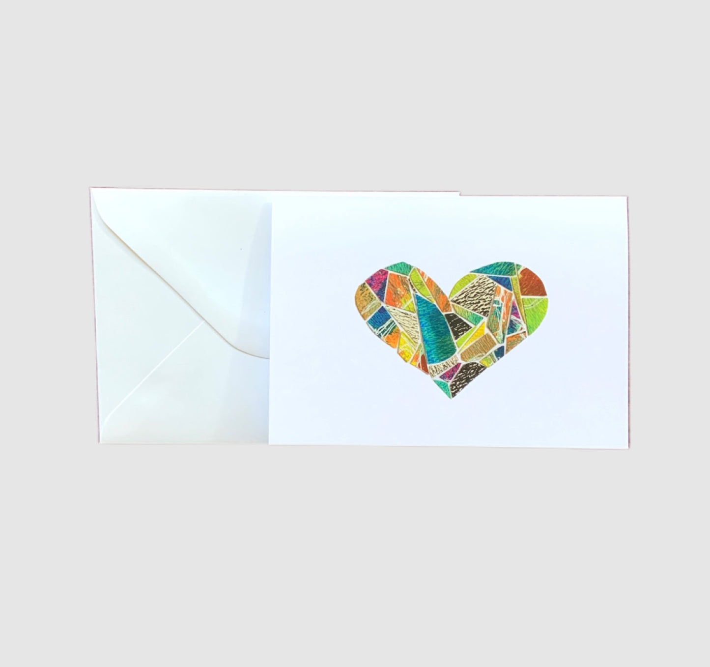 A colorful mosaic in the shape of a heart on the front of a greeting card.