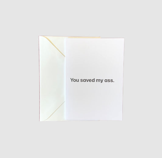 The words 'you saved my ass' on the front of a greeting card.