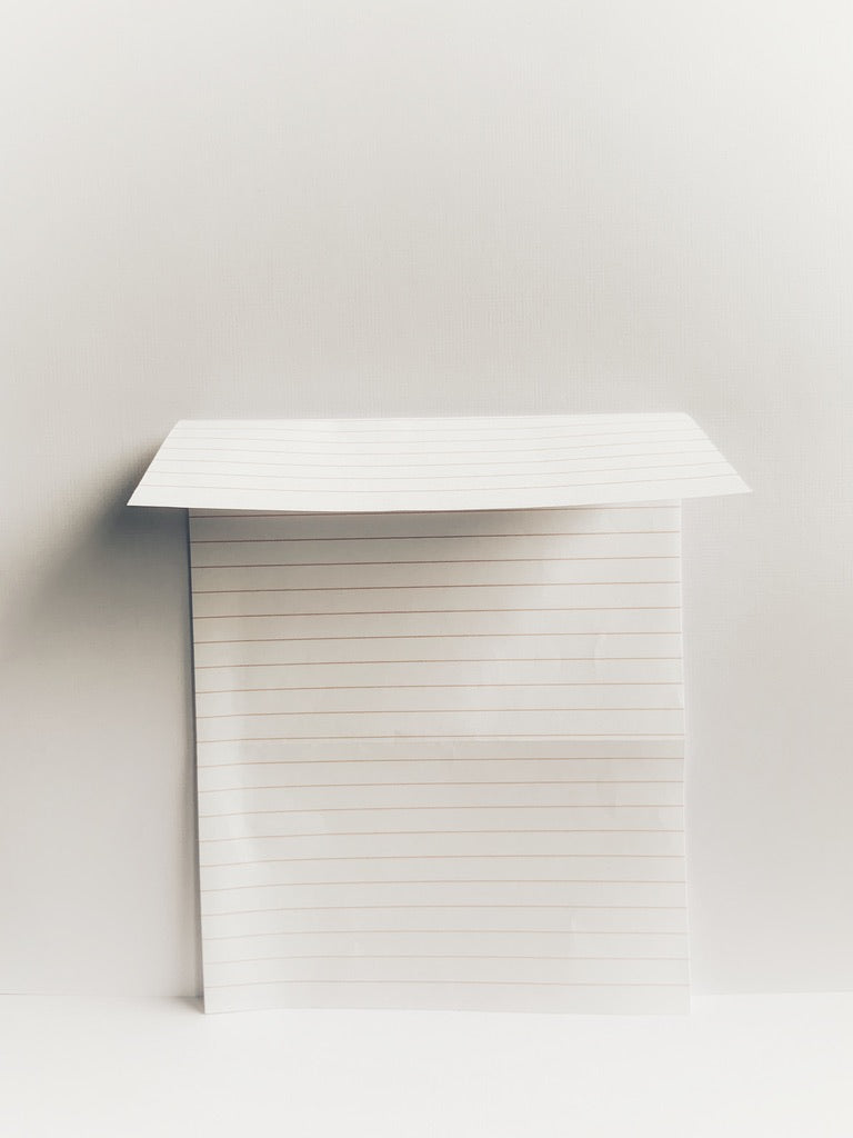 Lined notepaper with the top folded down
