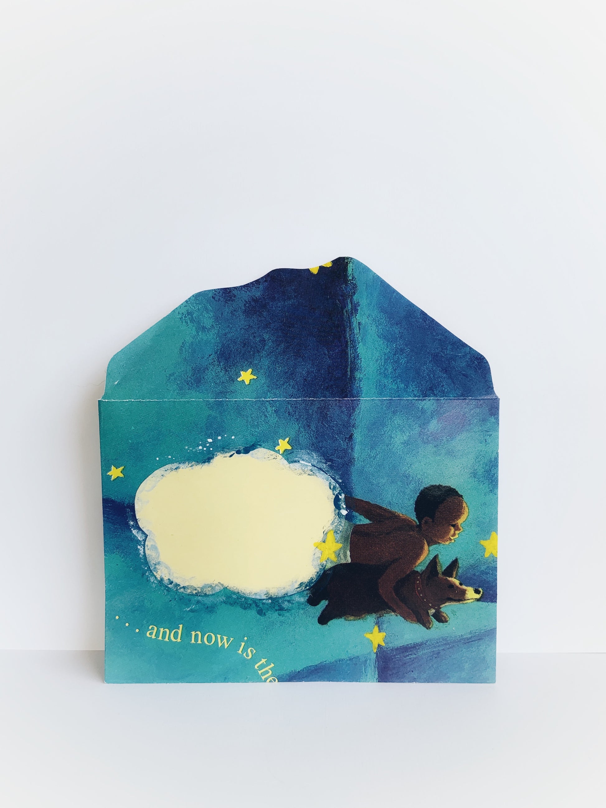 An envelope with a boy and his dog flying in a star-filled sky