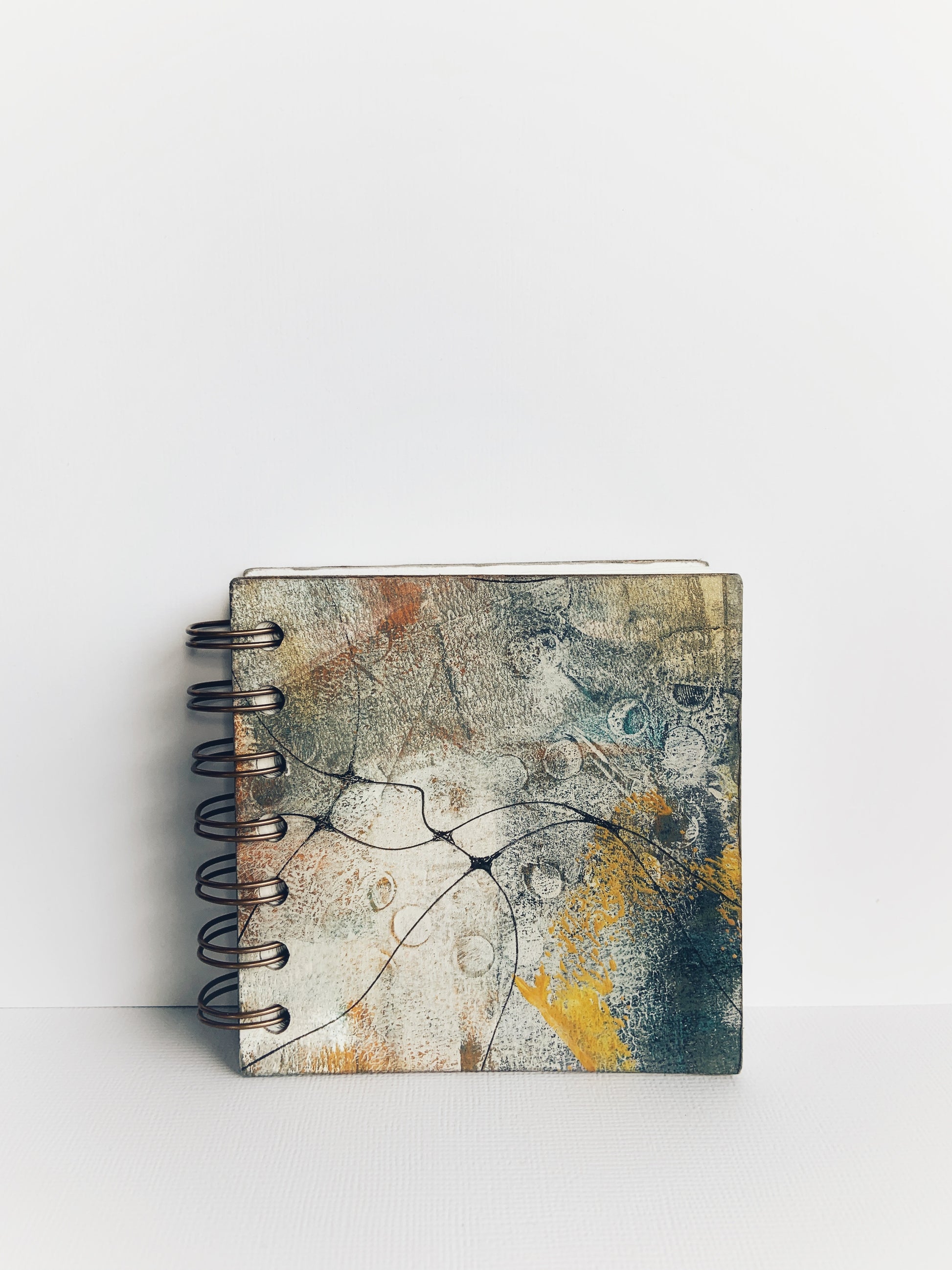 Handmade mini lined hardcover journal with painted front and back cover in grey, green and yellow tones with fine black neurographic lines