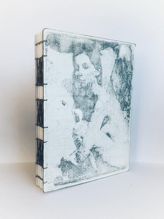 Handmade journal with a painted front cover of a woman in soft grey with a coptic and french link binding.