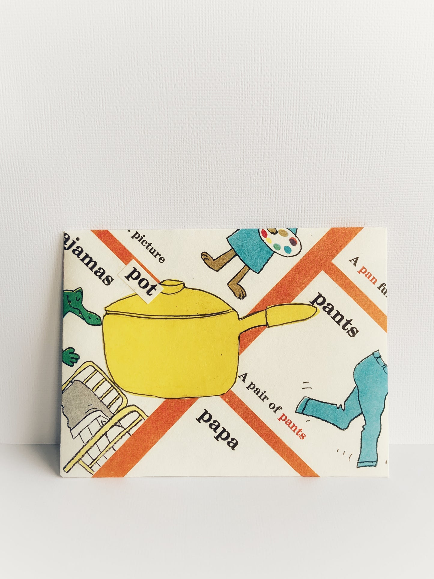 Front of a handmade children's envelope in blue, yellow and orange with words that start with 'p' 