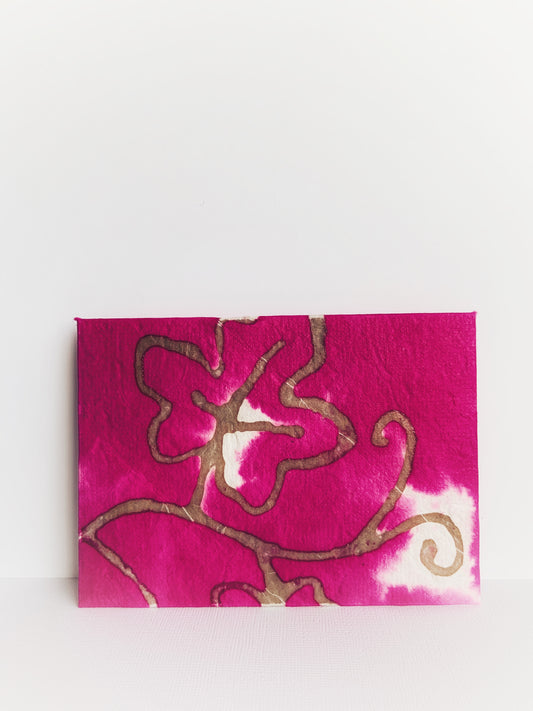 Front of handmade envelope made from pink handmade paper from Thailand with gold leaf.