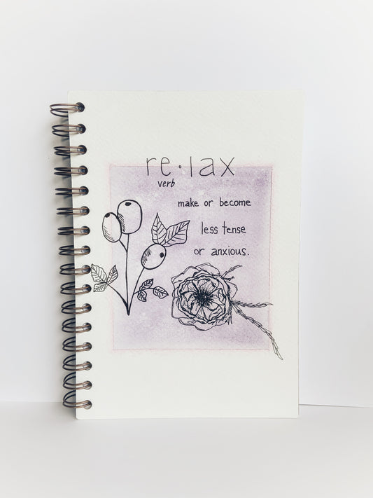 Front cover of a handmade journal showing the word 'relax' and the definition along with line drawing of rosehips and a flower.